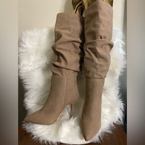 Tan leather boots with a gathering on them. Heel is 4in. Never worn.
